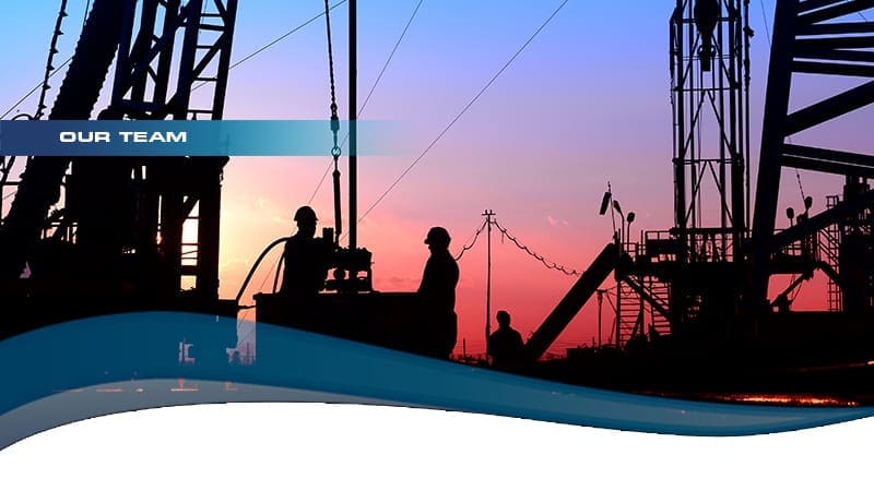 workers on an oil rig at sunset